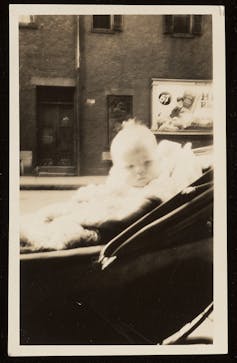 A baby sits in a stroller