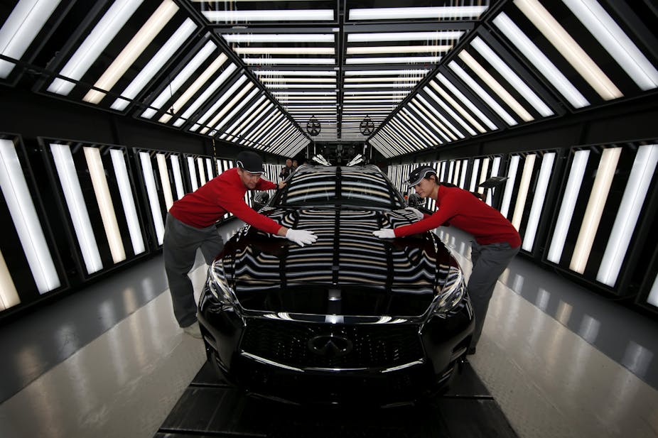 Two Nissan workers on the production line of the Infinity Q30