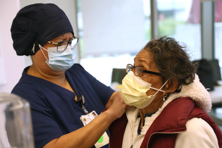 An elderly woman is about to receive the COVID-19 vaccine.