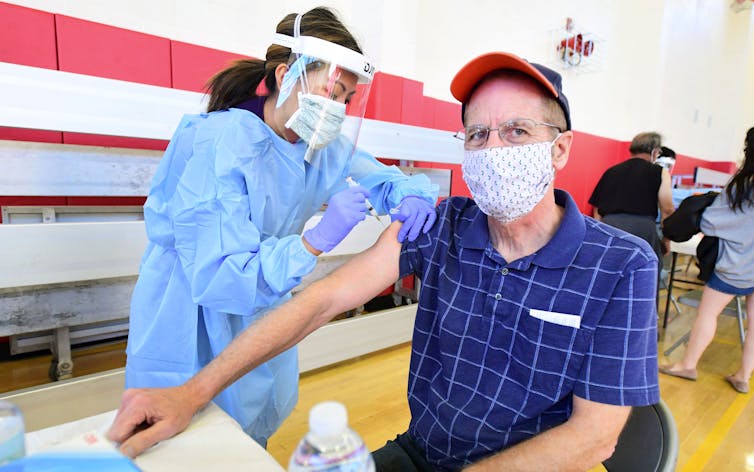 A man receiving the COVID-19 vaccine.