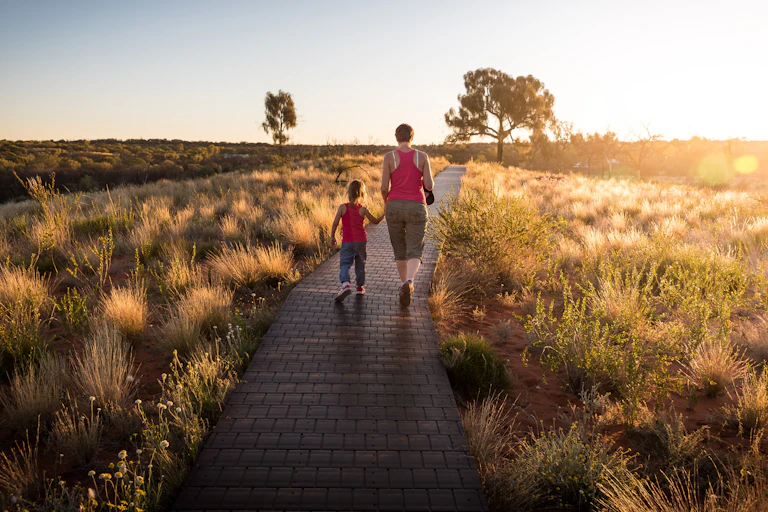 daughter and mother walk outside together
