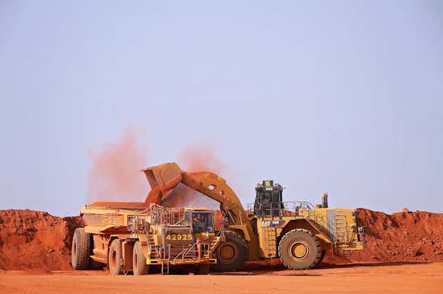 Mining site, red dust, trucks