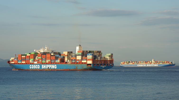 Container ship with COSCO SHIPPING written on hull, another ship in the distance