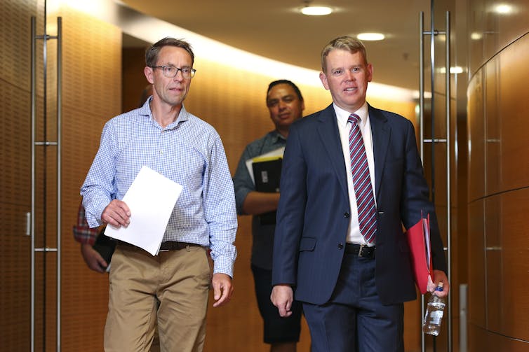 Ashley Bloomfield and Chris Hipkins walking in parliament corridor