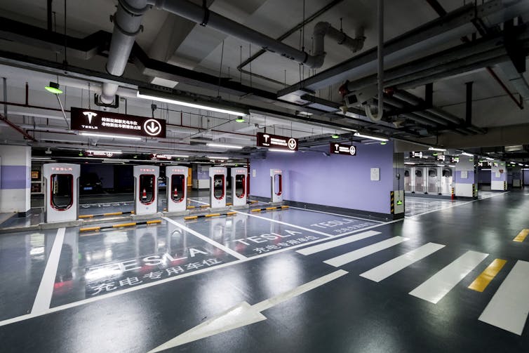 Tesla's 'supercharger station', in the car park of a Shanghai office complex, is the largest yet built, with capacity for 72 vehicles.