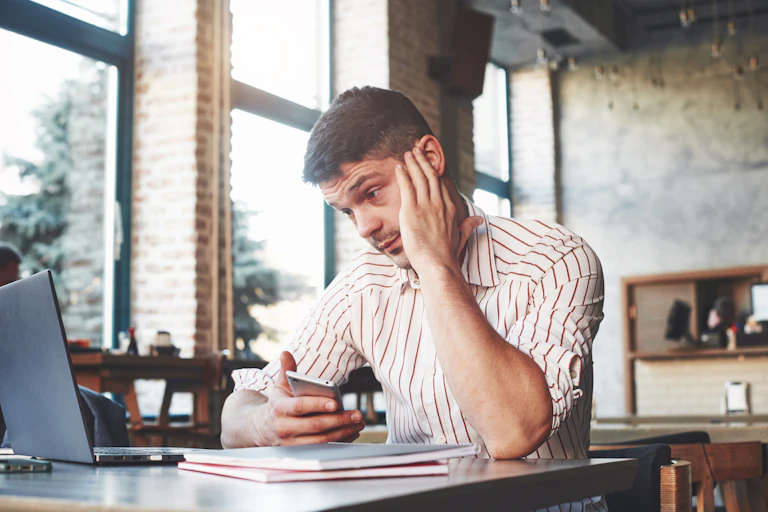 Man trying to understand something on computer in a cafe.