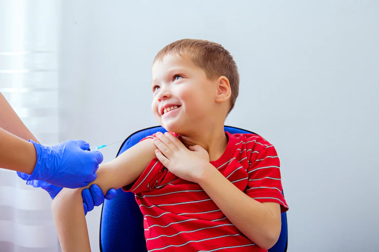 A young boy is about to receive a vaccination.