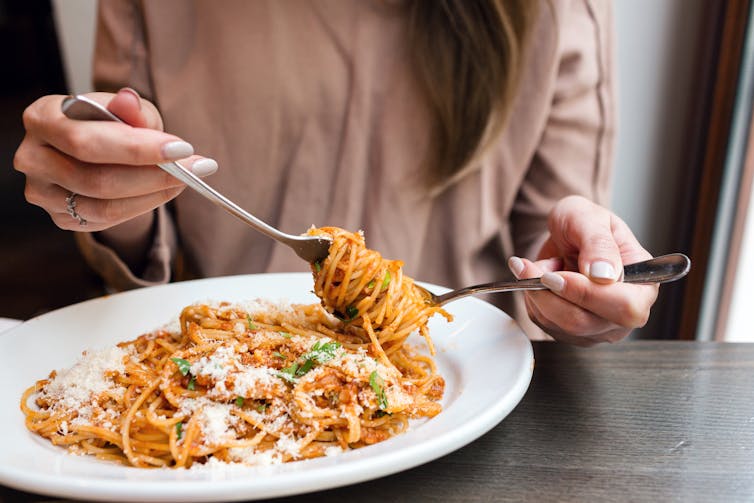 Person eating pasta