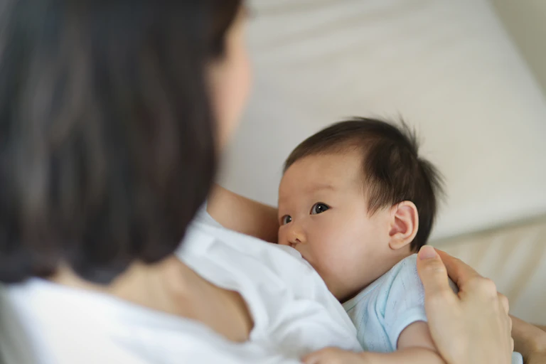 A mother is breastfeeding her child