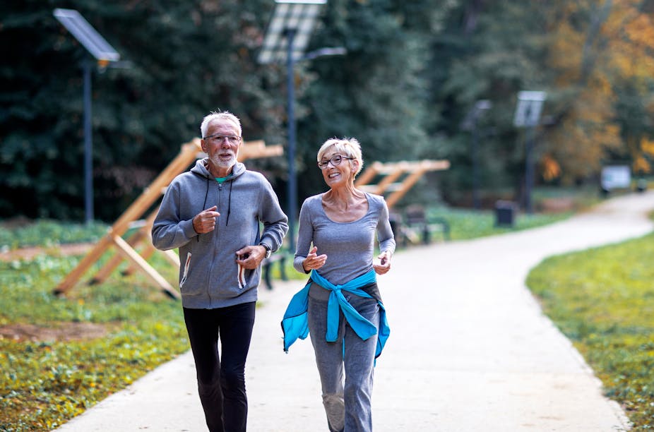 Older couple jogging in the park.