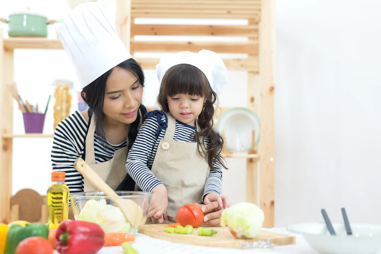 Mother and daughter chopping vegetables