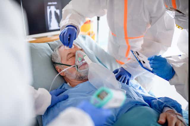 Image of an infected patient in quarantine lying in bed in hospital.