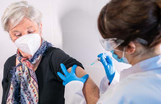 An older woman being vaccinated