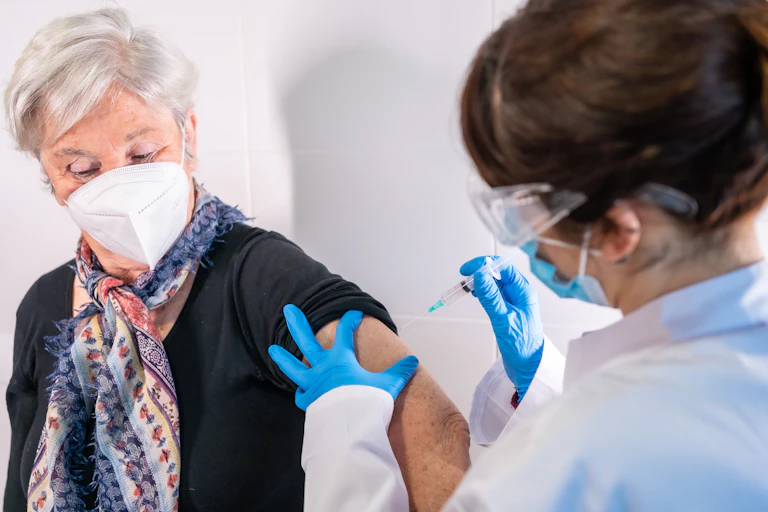 An older woman being vaccinated