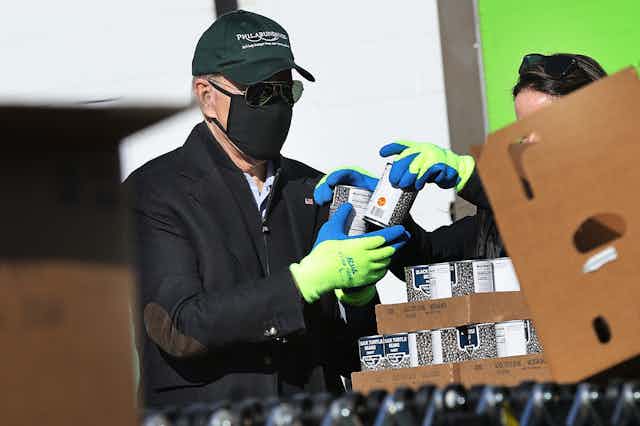 Joe Biden helps volunteers fill food donation boxes at the Philabundance food bank during the Martin Luther King National Day of Service on January 18, 2021 in Philadelphia, Pennsylvania. 
