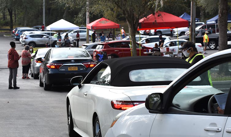 People line up in their cars to receive a second dose of the vaccine.