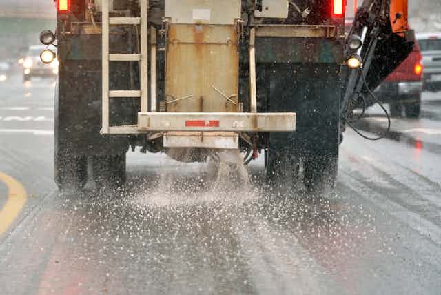 Truck spreading deicing salts on street