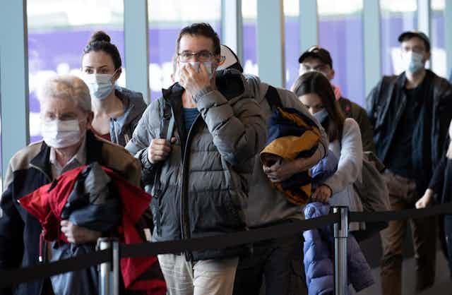 Airport passengers in masks