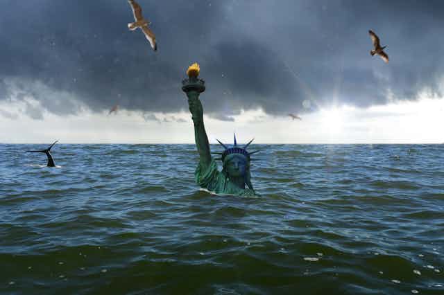 The Statue of Liberty pokes above the raised sea.