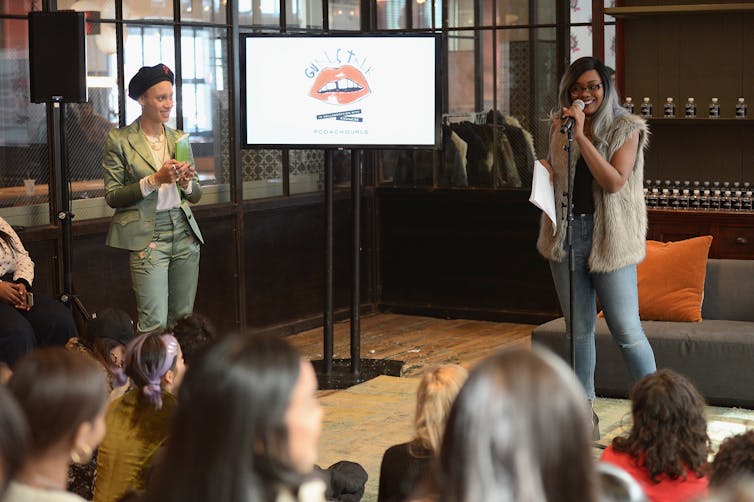 An African American woman speaks to a crowd of people.