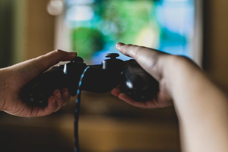 Close up shot of hands on a video game controller.