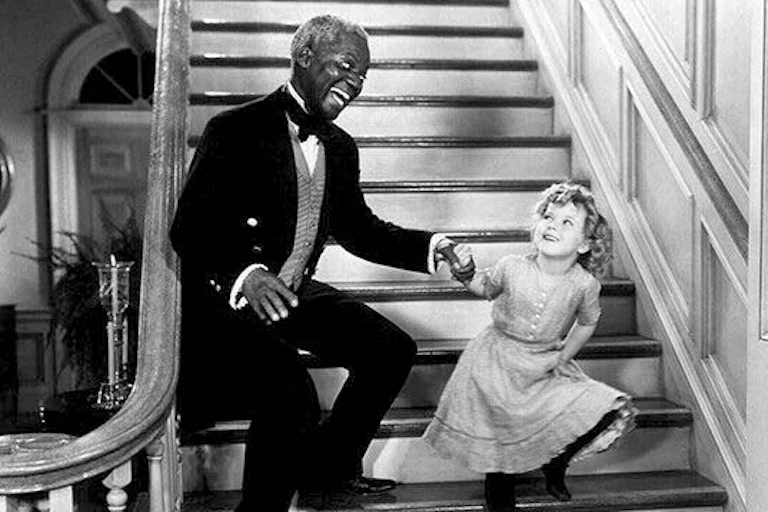 Bill and Shirley dancing on a staircase.