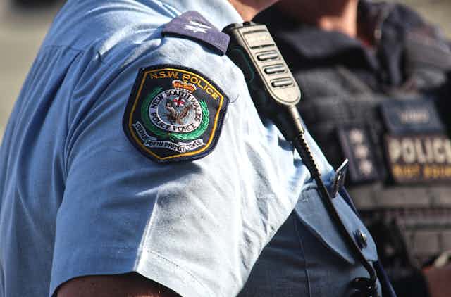 NSW Police officer showing badge and radio