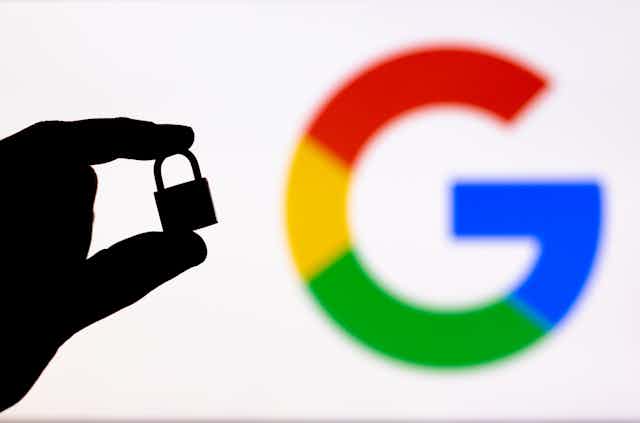 Hand with lock poses in front of Google Crome logo.