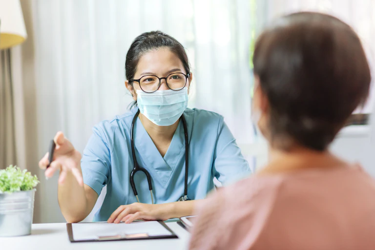 A doctor consults with a patient.