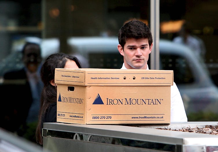 Man looking sad with cardboard box.