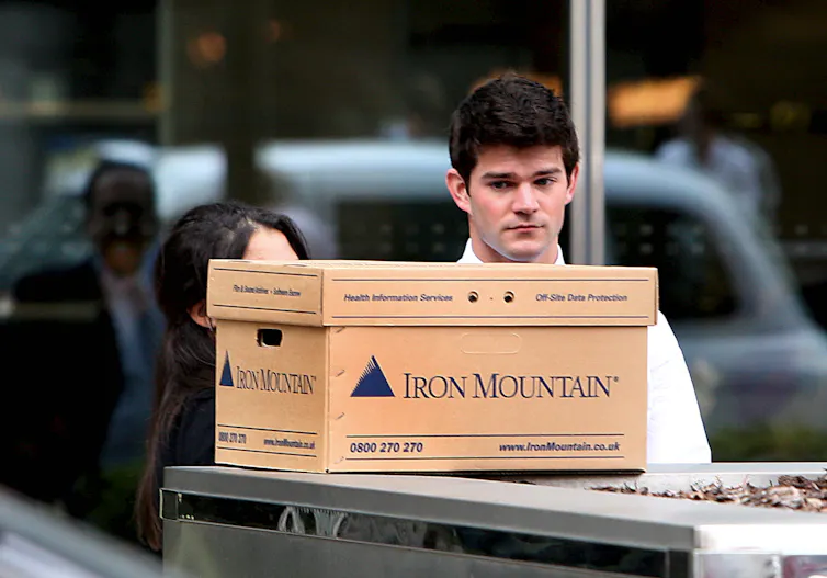 Man looking sad with cardboard box.