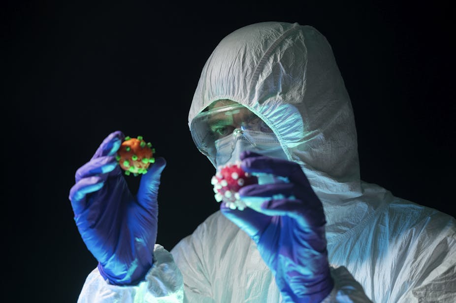 Man holding two types of viruses.