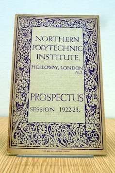 Cover of old prospectus, with college name in large letters, surrounded by decorative border.