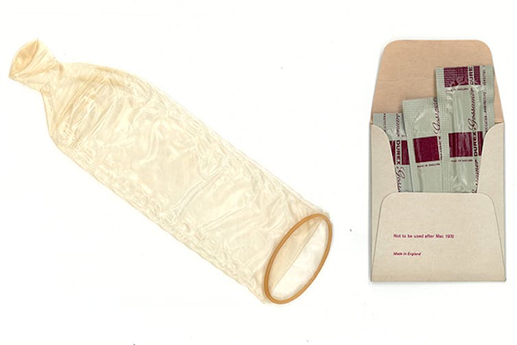 An unwrapped, unrolled 1967 condom, and a packet of three wrapped one.