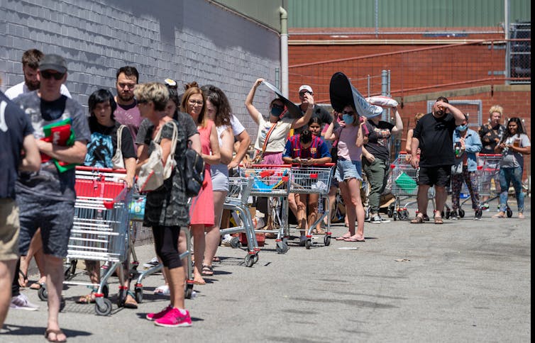 Shoppers queue outside a supermarket in Maylands, Perth