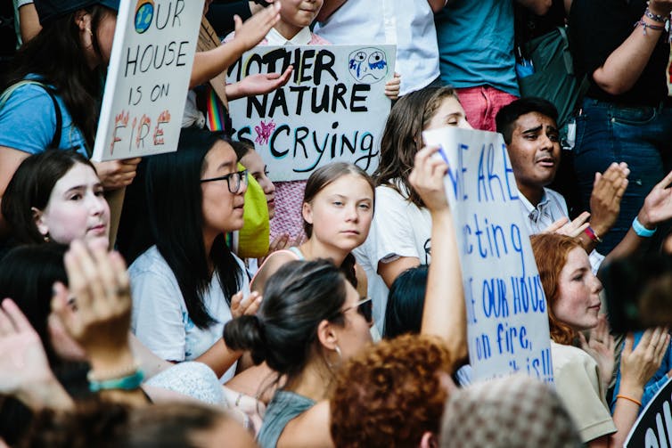 Greta Thunberg sitting among climate protesters outside the United Nations.