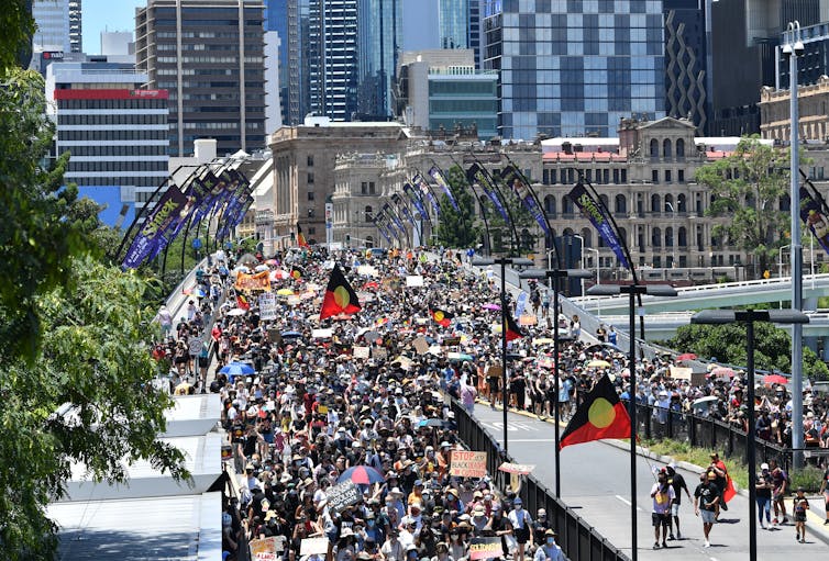 Protesters crossing the Victoria Bridge in Brisbane.