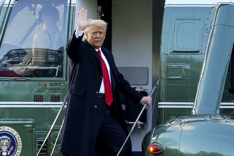 Donald Trump boarding a helicopter as he leaves the White House.