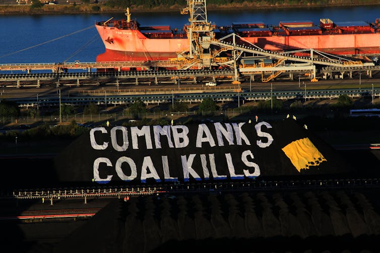 Protest banner on coal pile at terminal