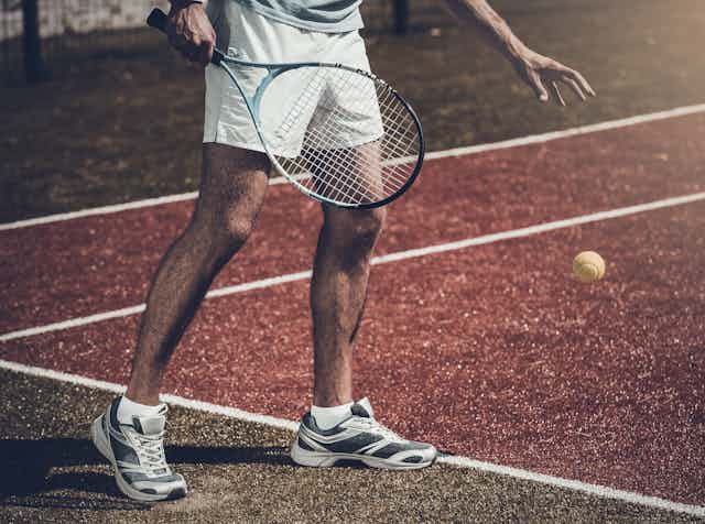 An unknown tennis player shown only from chest down.