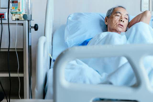 Elderly person in hospital bed