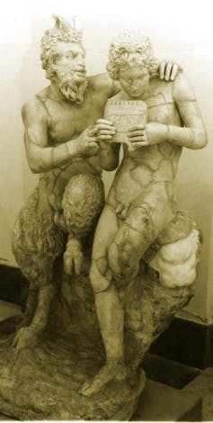 A stone statue of Pan and Daphnis, half humans half goats.