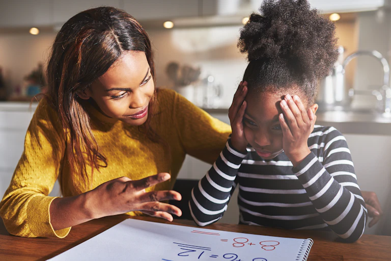 Mother helping daughter with maths