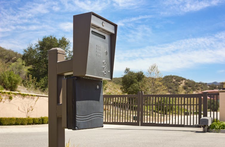An intercom at the entrance of a gated community.