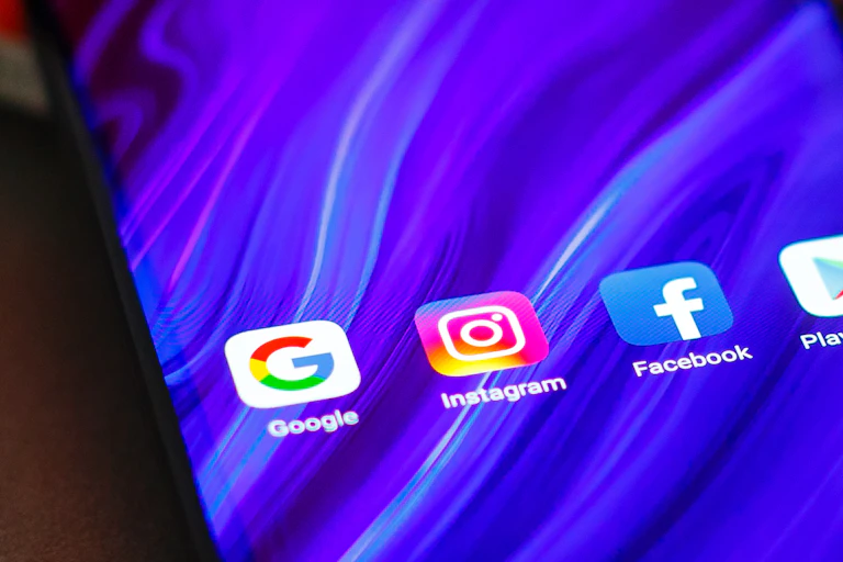 Phone with Google and Facebook icons displayed.