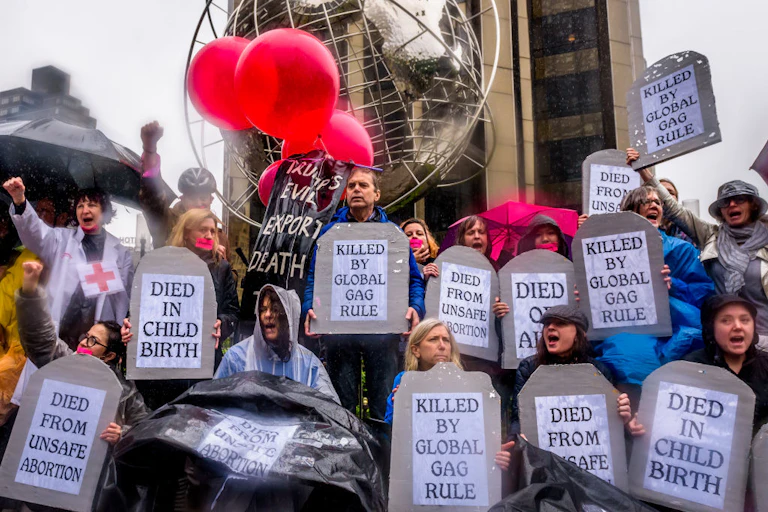 Group of people holding posters and raising fists