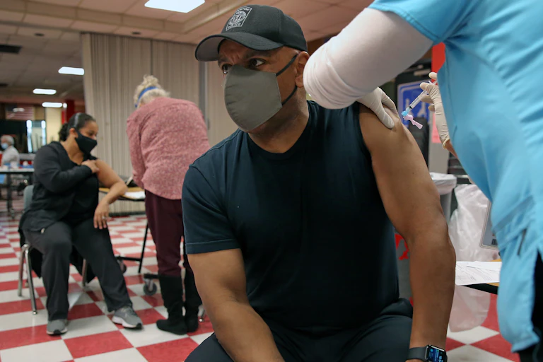 A police detective receiving the Covid-19 vaccine shot.