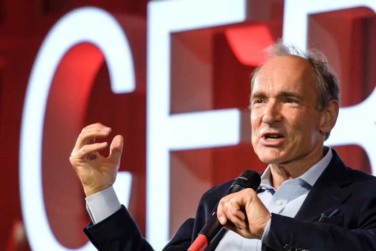 Tim Berners-Lee speaking with a microphone at a CERN meeting