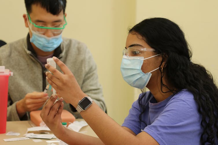 Students practice vaccination techniques