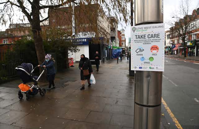 A government coronavirus notice is displayed in Ealing, London, warning people to 'Take Care'.